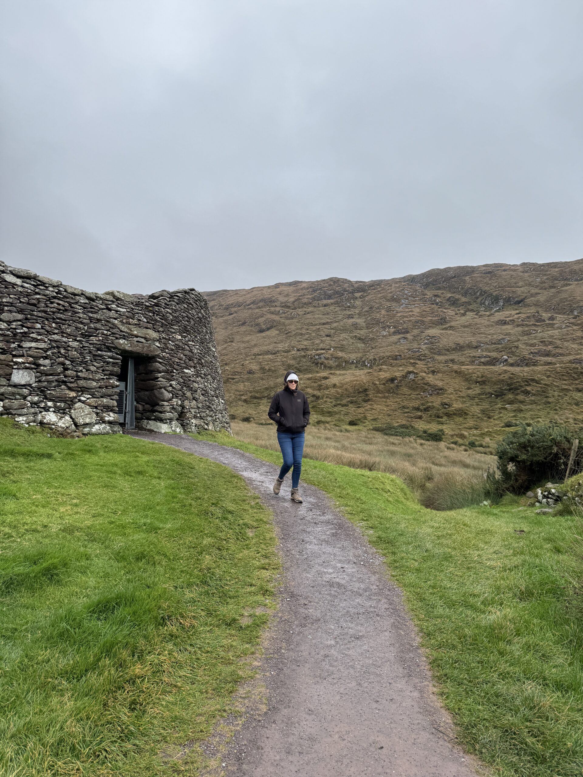 Dariece on a trail at the Gap of Dunloe with mountains and valley below, County Kerry