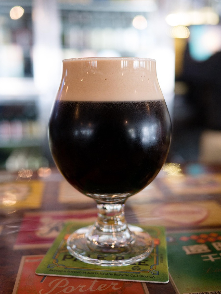 Dark stout beer being poured in an Irish pub