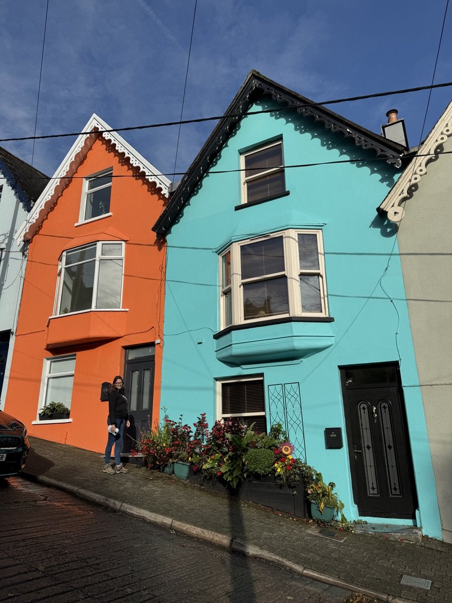 Brightly painted orange and turquoise houses on West View street in Cobh, Ireland