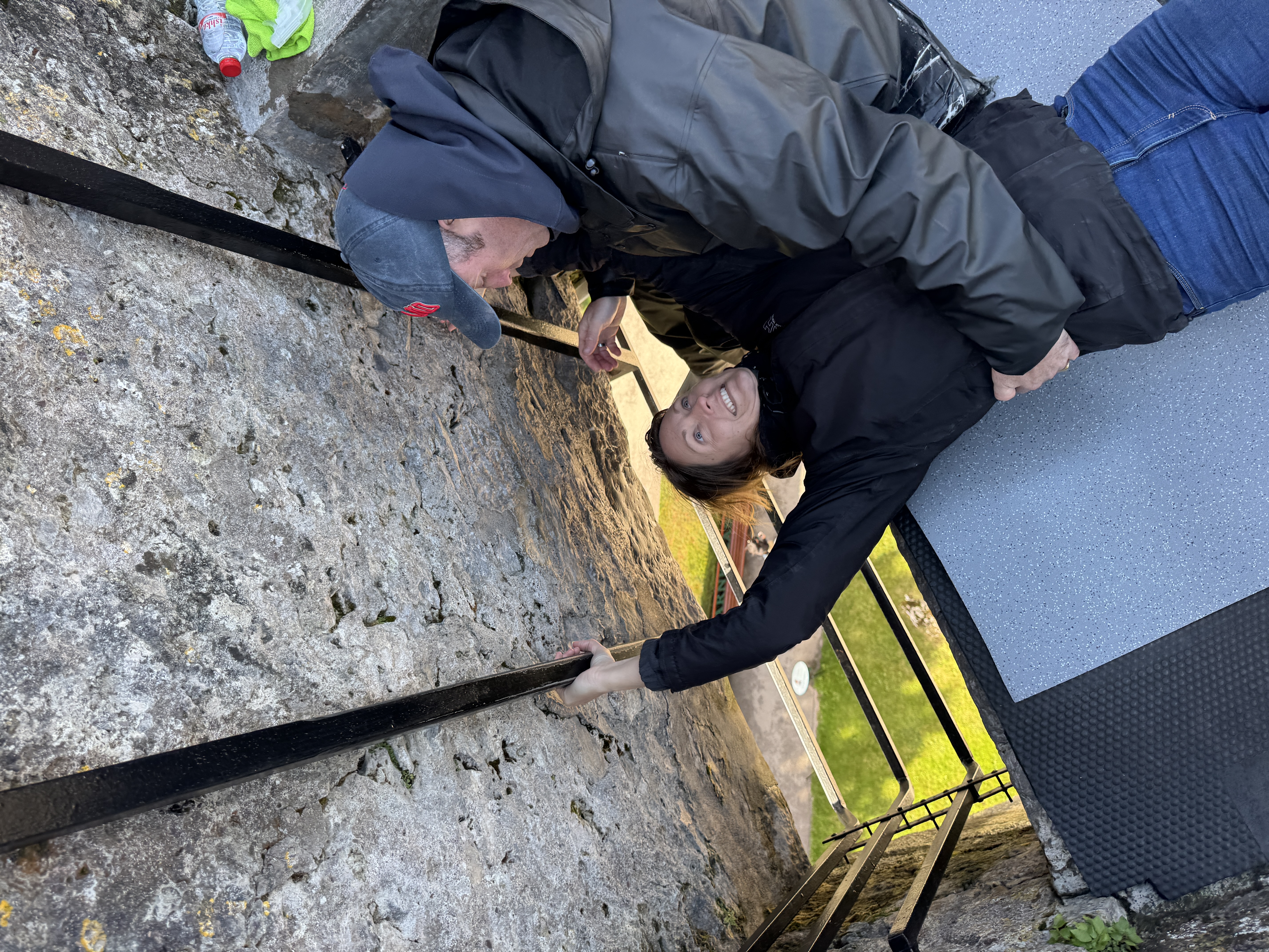Couple kissing the Blarney Stone at Blarney Castle, Cork, Ireland