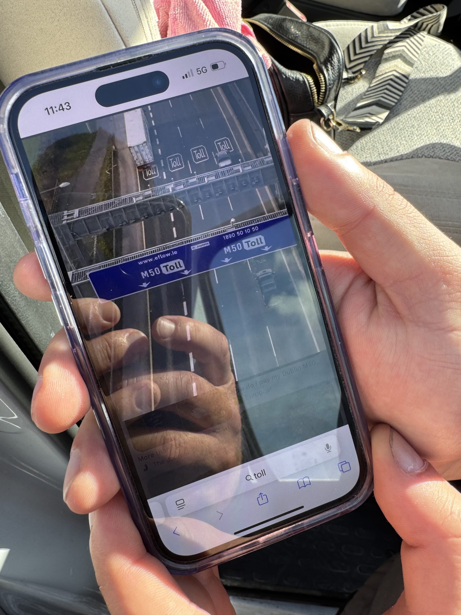 A phone showing the M50 toll road information relevant to driving in Ireland