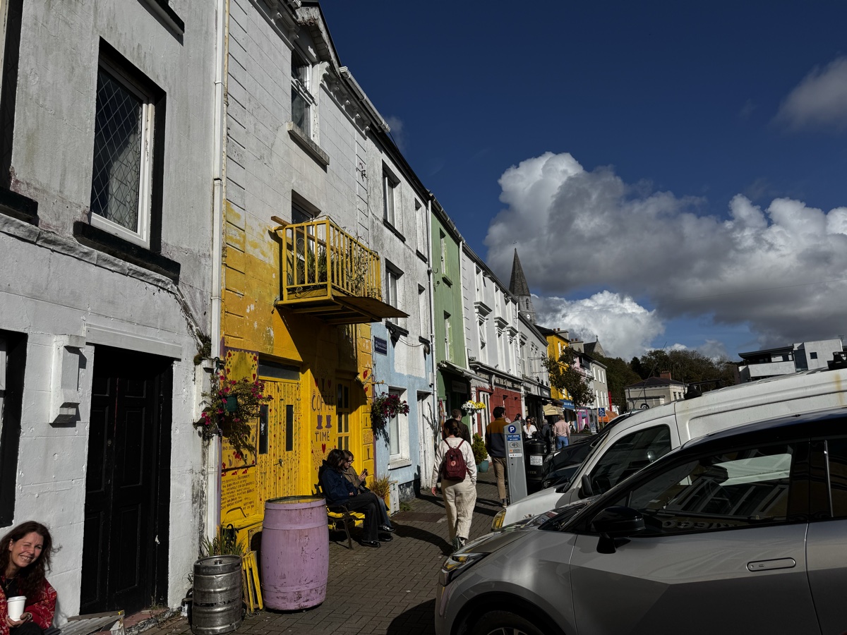 Shops and parked cars on a street in Clifden