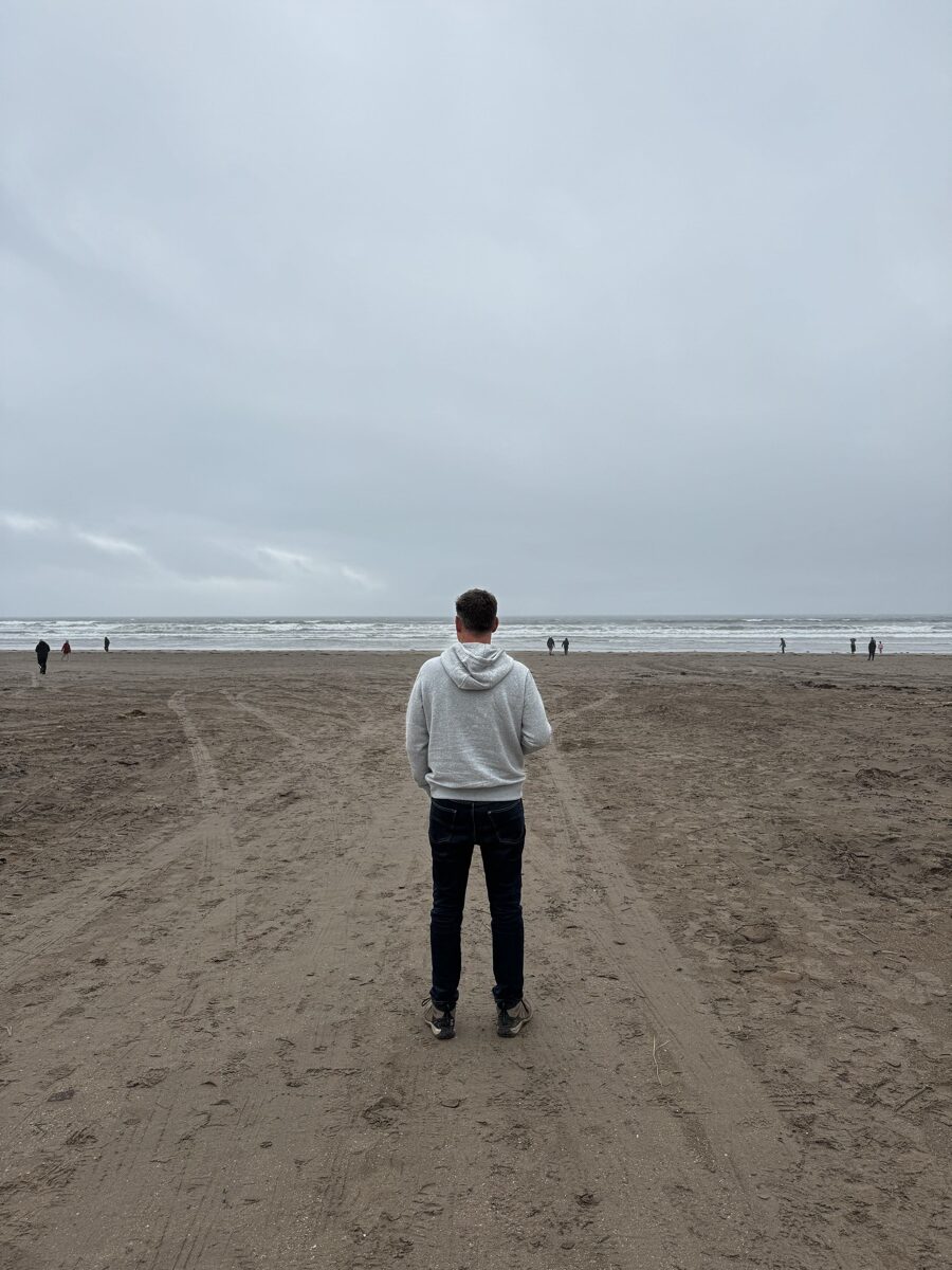 Man on overcast Inch Beach along R561 in Dingle Peninsula, Ireland