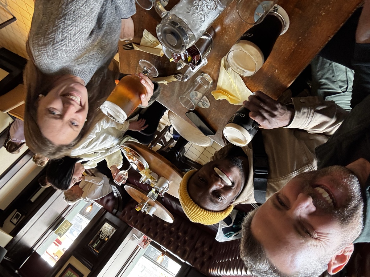 Friends enjoying pints of Guinness at a traditional Dublin pub