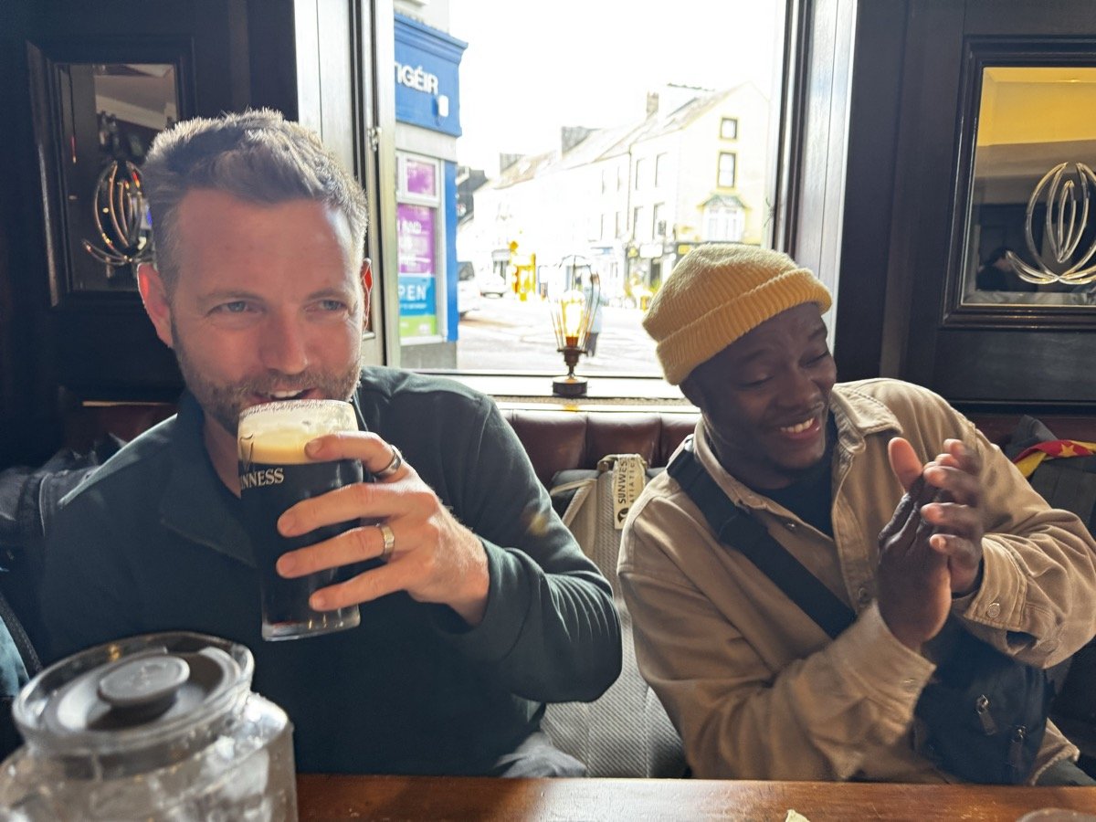 Friends enjoying pints of Guinness at a traditional Irish pub in Ireland