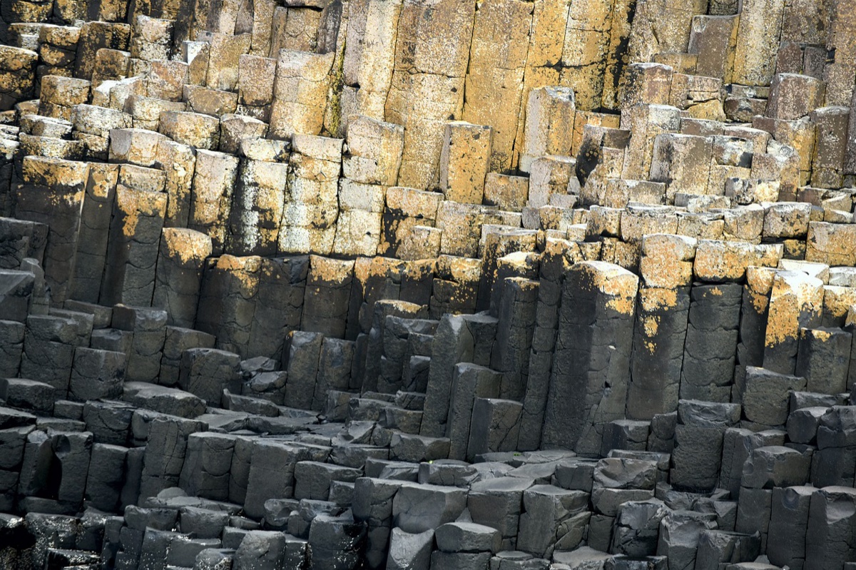 ancient basalt columns stacked like nature's own cathedral at fingal's cave