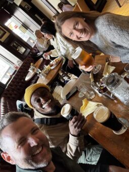Friends enjoying pints of Guinness and beer at a traditional Dublin pub on Pearse Street, Ireland