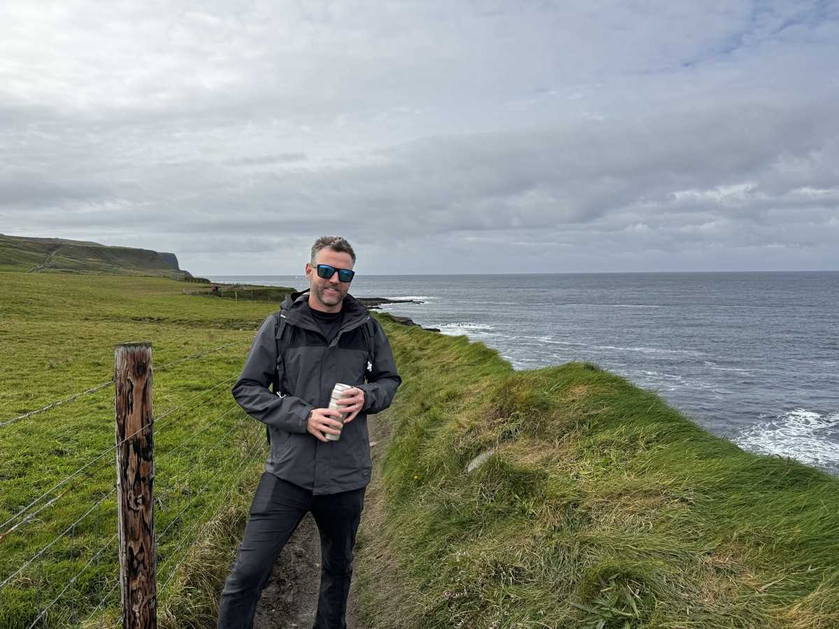 Nick with a thermos on the coastal cliff path at the Cliffs of Moher, County Clare, Ireland