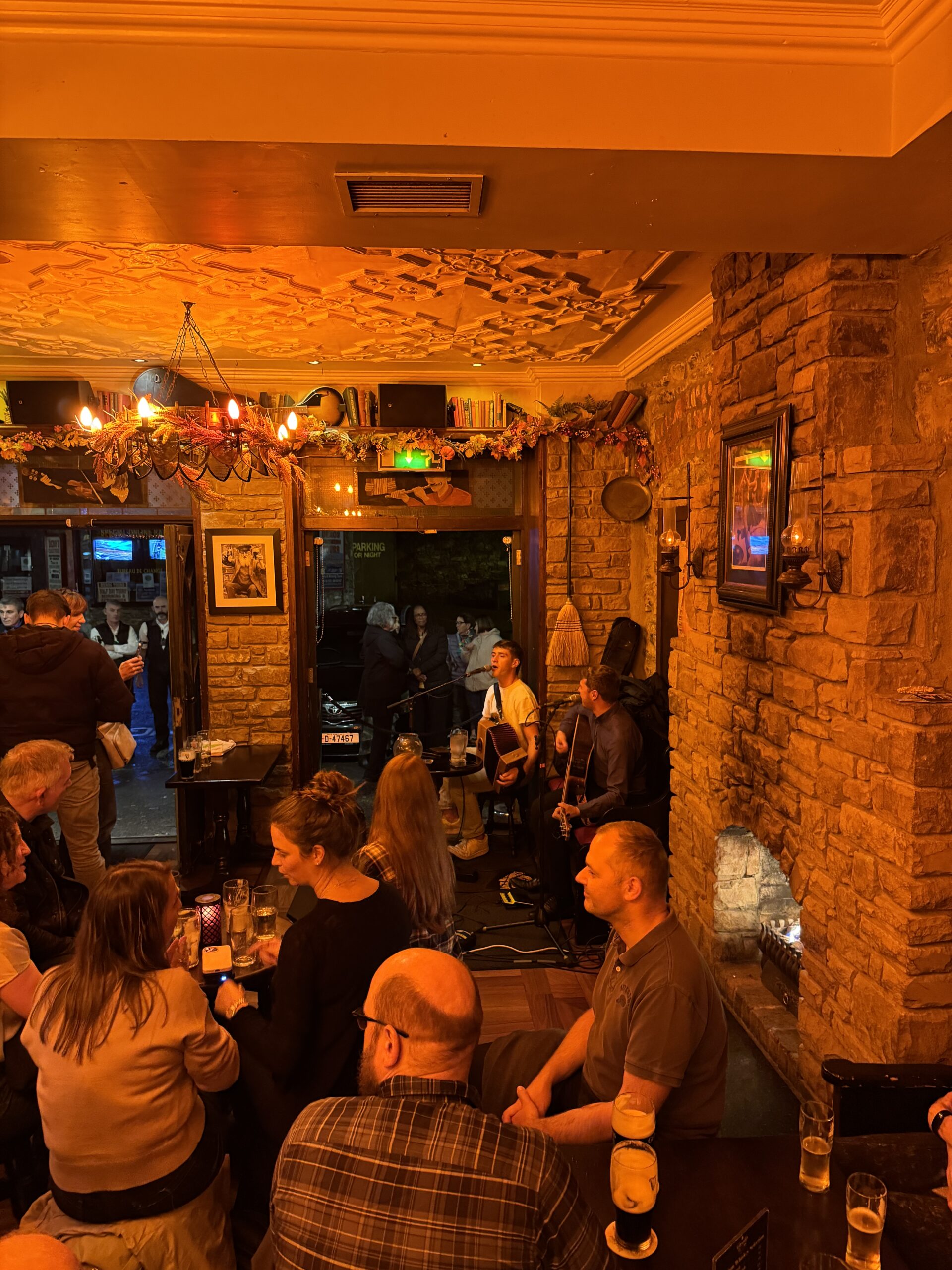 Traditional Irish music session at The Grand pub in Ireland with crowd enjoying live performance