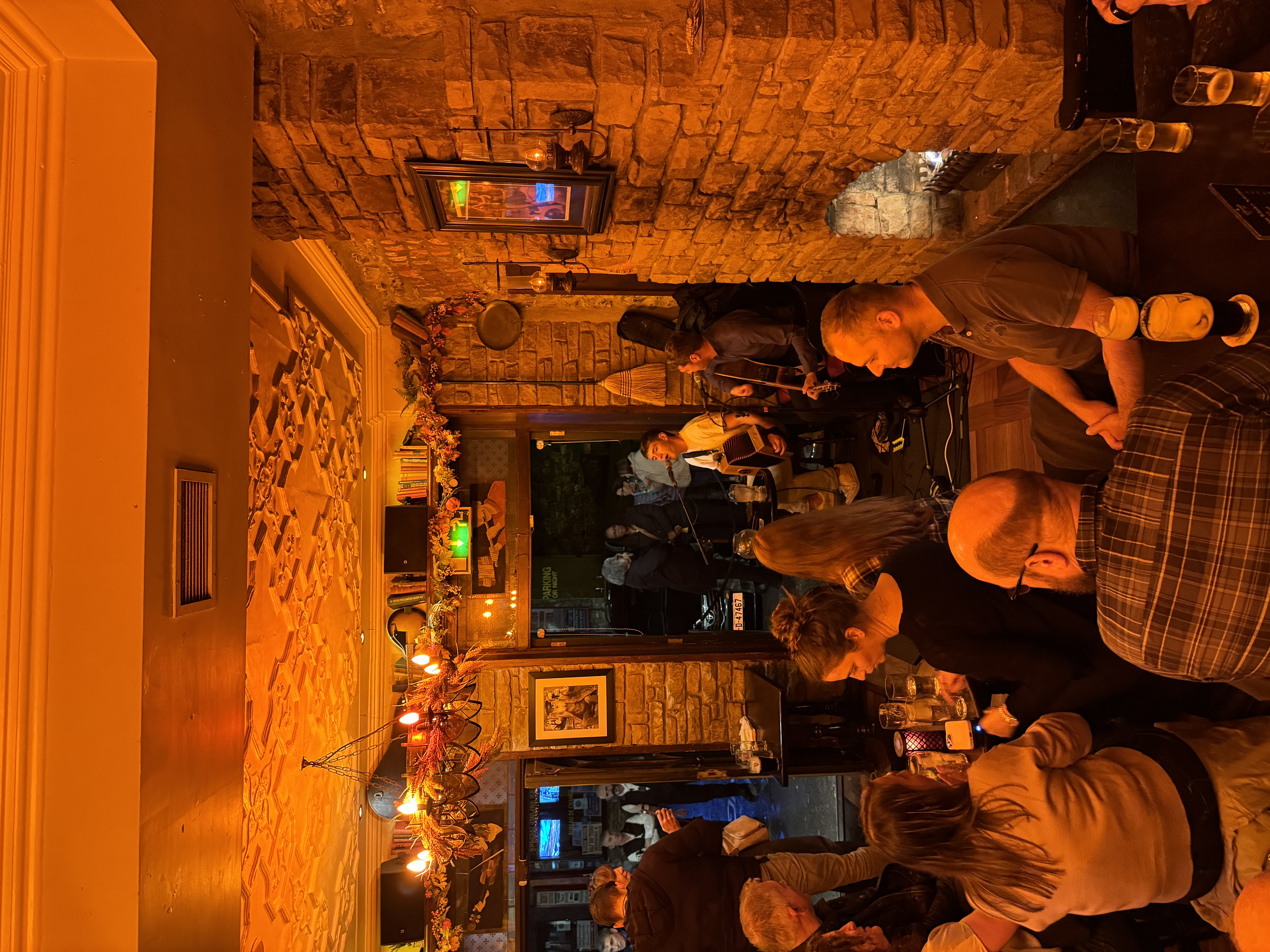 Traditional Irish music session at The Grand pub in Ireland with crowd enjoying live performance