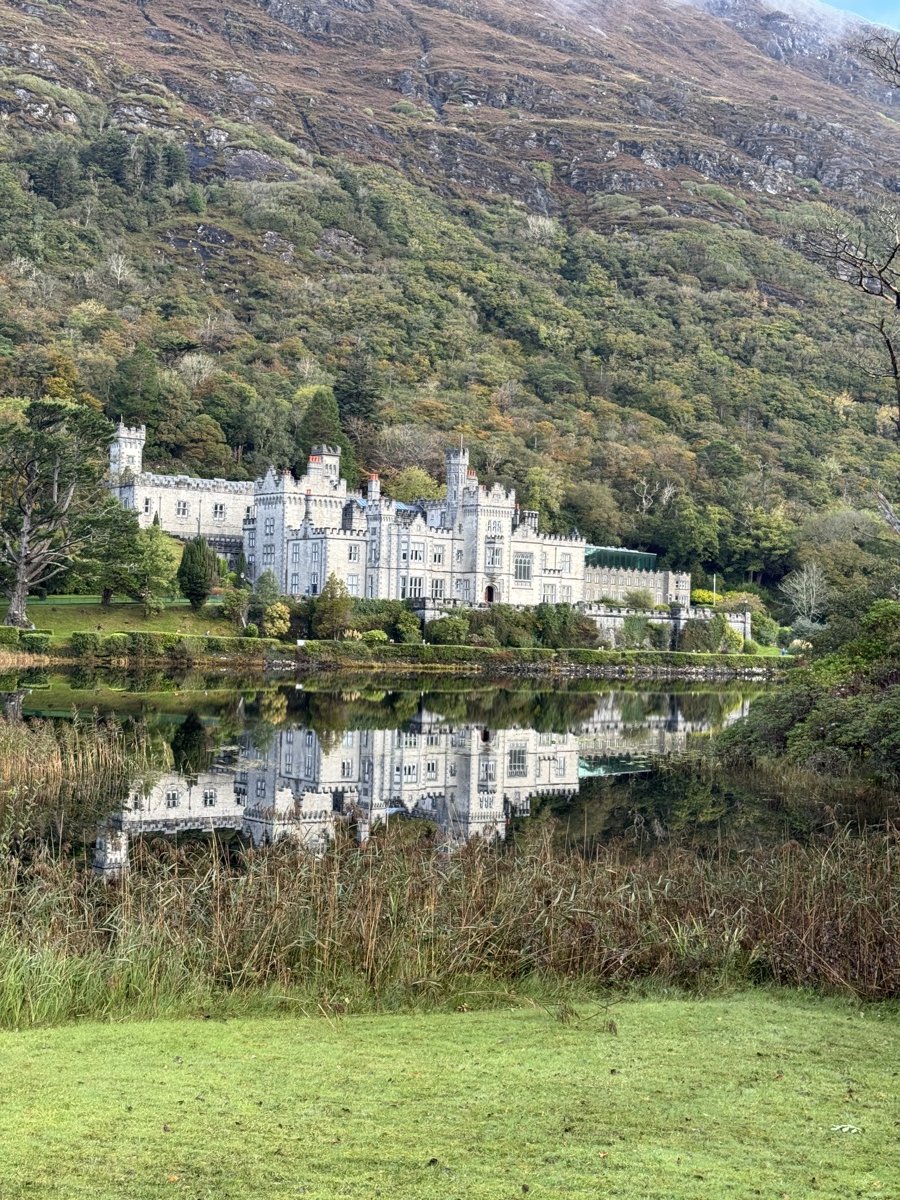 Kylemore Abbey castle reflected in tranquil lake in Connemara, County Galway, Ireland