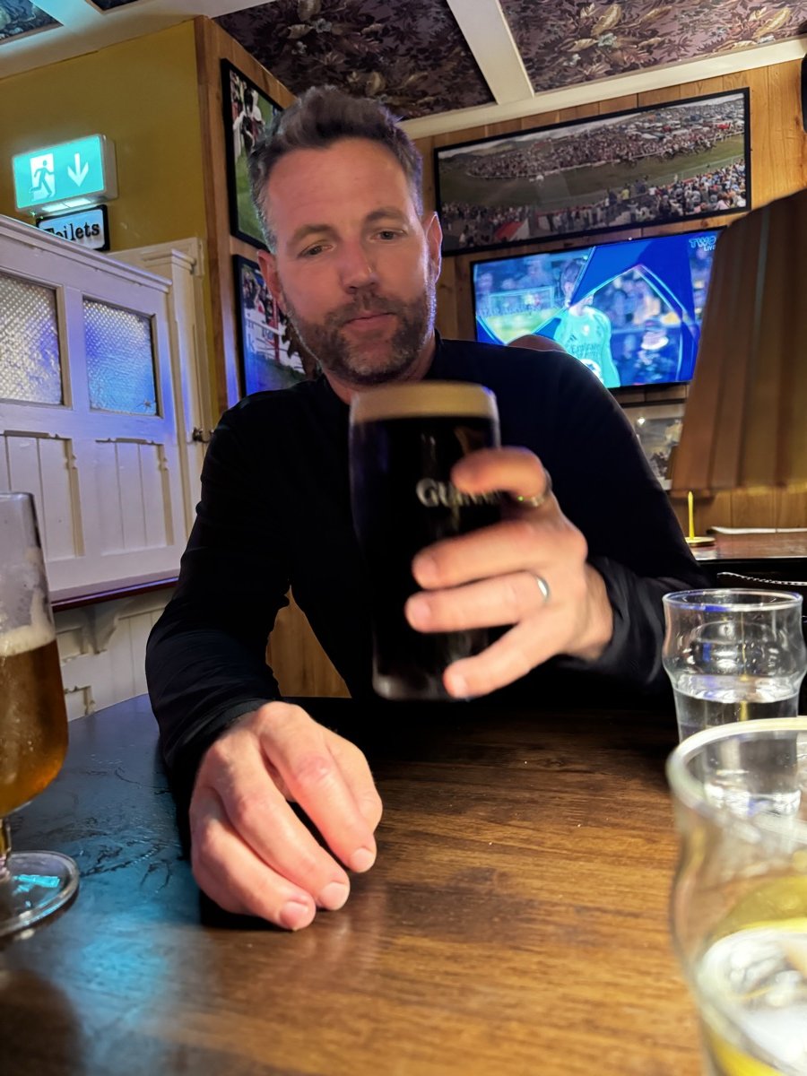 Man enjoying a pint of Guinness in a traditional Irish pub