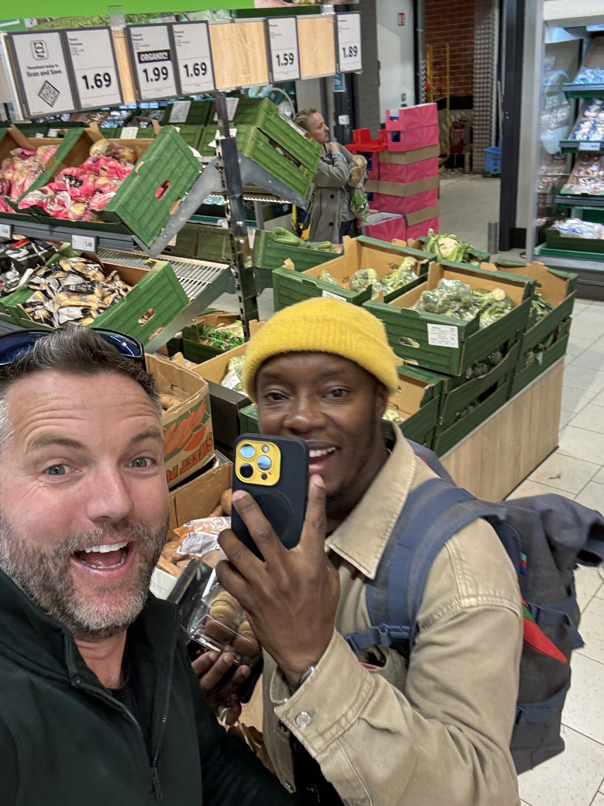 Nick and friend stocking up on groceries in an Irish supermarket during a campervan road trip