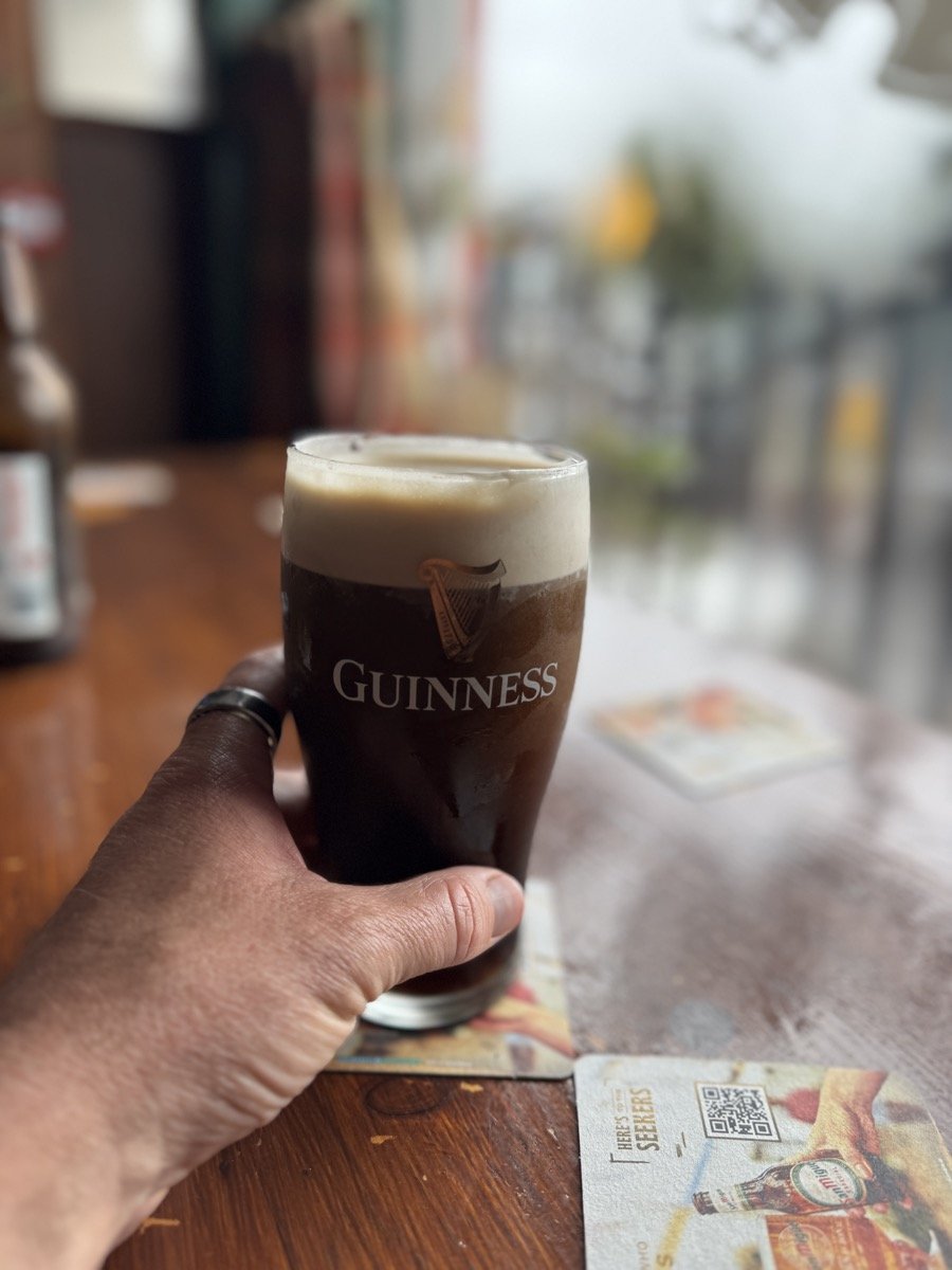 Pint of Guinness held in hand in Ireland