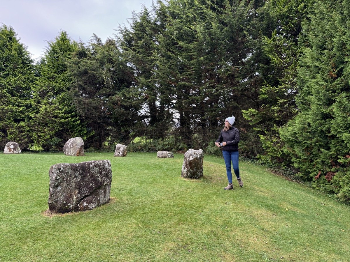Woman exploring the Kenmare Stone Circle in County Kerry, Ireland