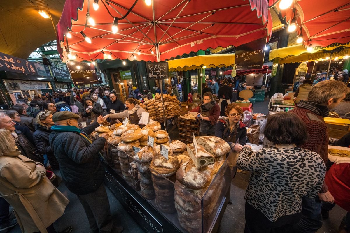 A busy outdoor market with food and craft stalls like the Galway Market