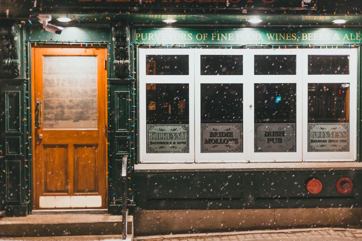 Lit-up Irish pub front on a snowy street