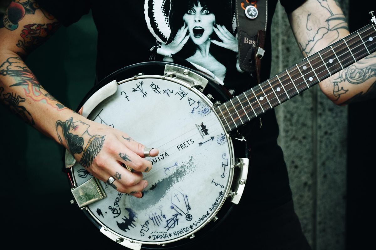 Musician playing banjo at a pub session