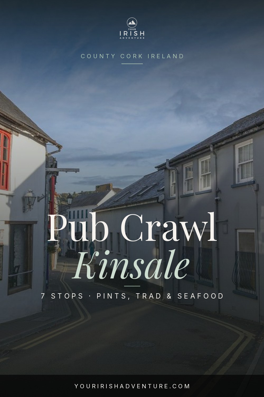 Pint of stout on a wooden pub table in Kinsale Ireland with harbour view in background