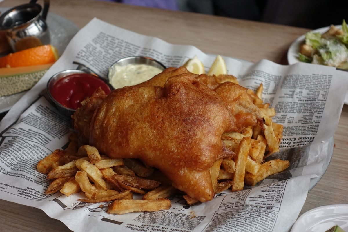 Fresh fish and chips served on newspaper