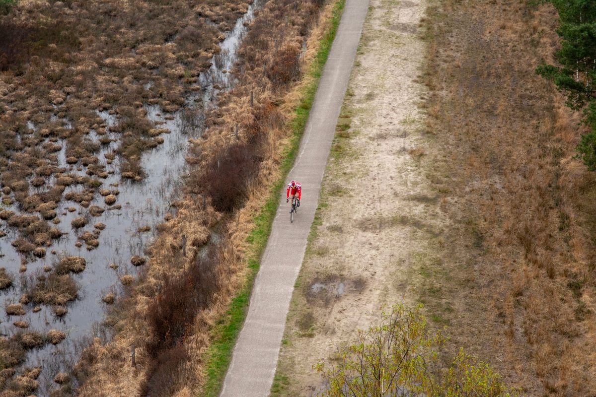 Cyclist on the Great Western Greenway trail beside a bog