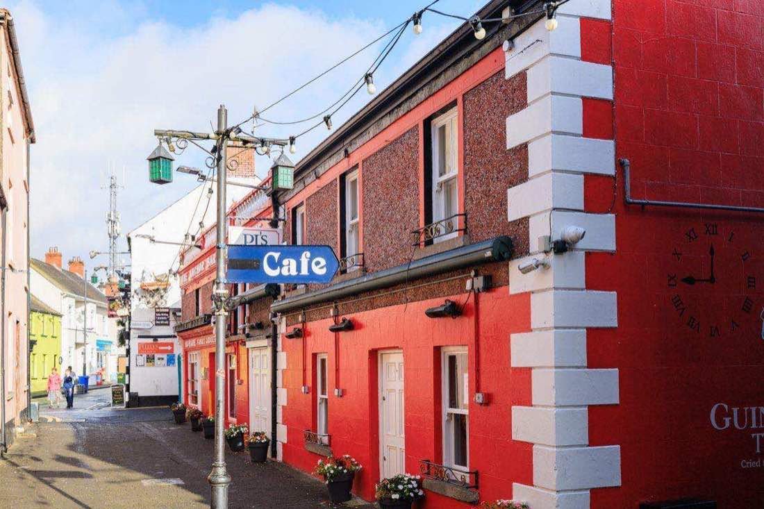 A colorful small-town street in Donegal with a cafe and pubs