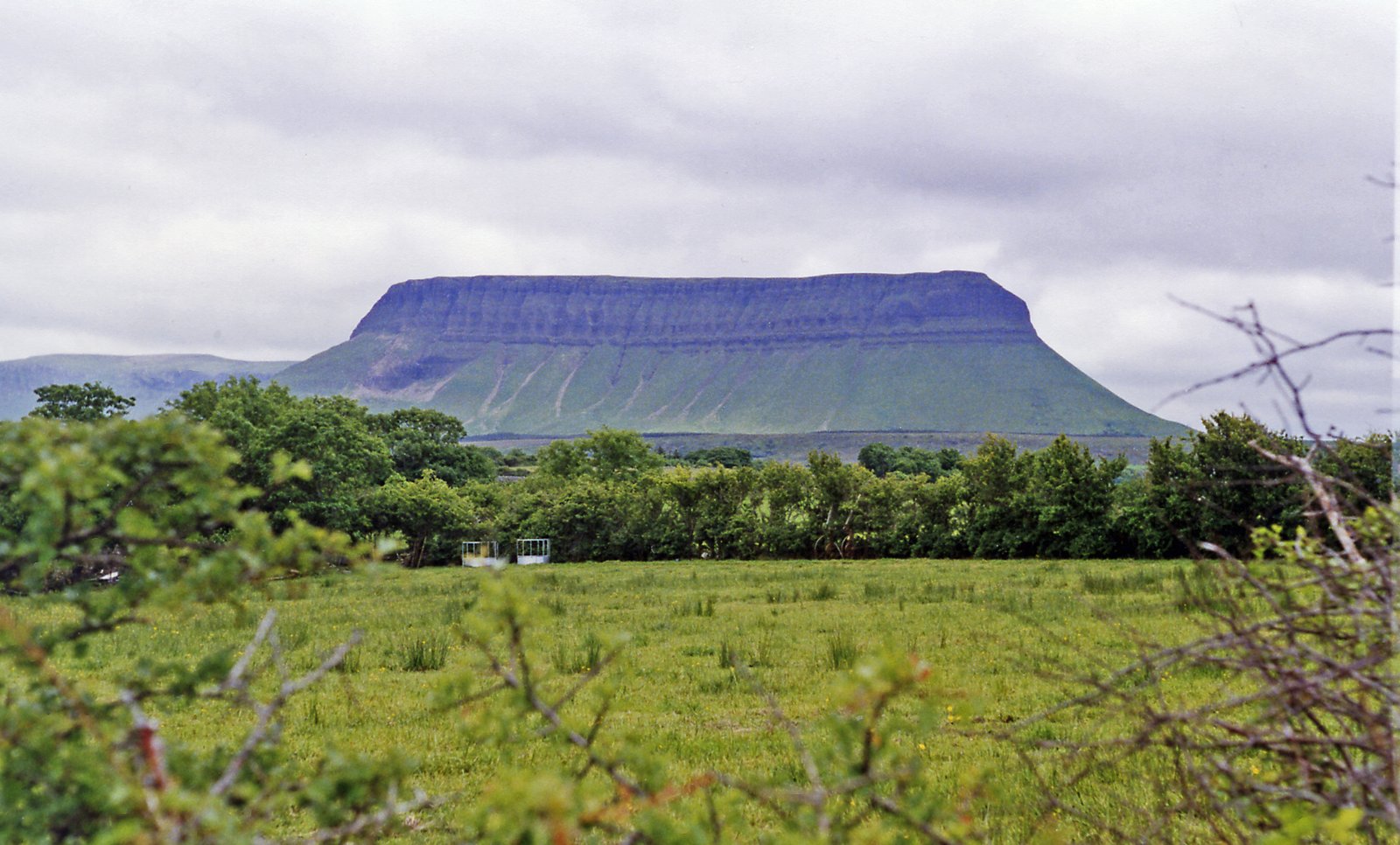 The flat-topped profile of Benbulben rising above green fields in Sligo