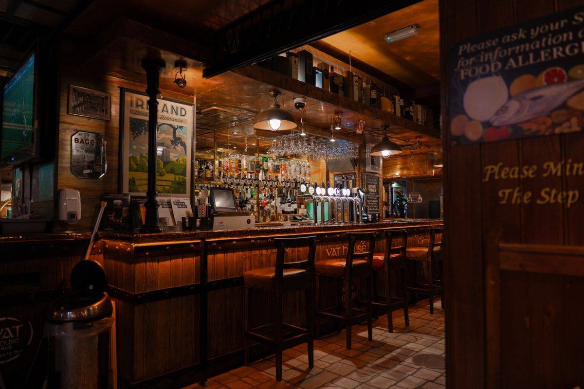 Traditional Irish pub interior with a wooden bar and warm lighting