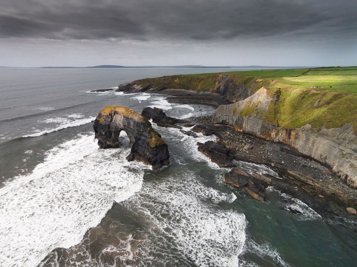 Wild Atlantic cliffs and surf on an overcast Irish day