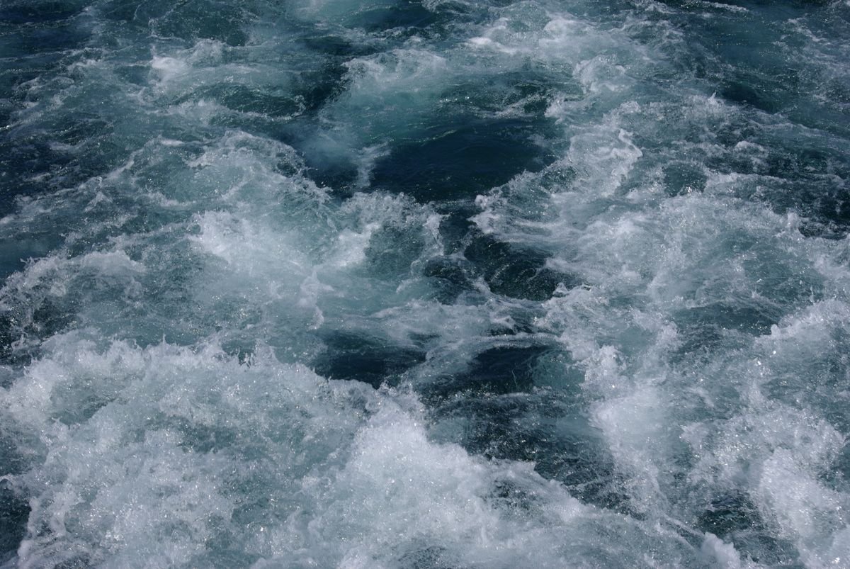 Close-up of churning white surf and dark water