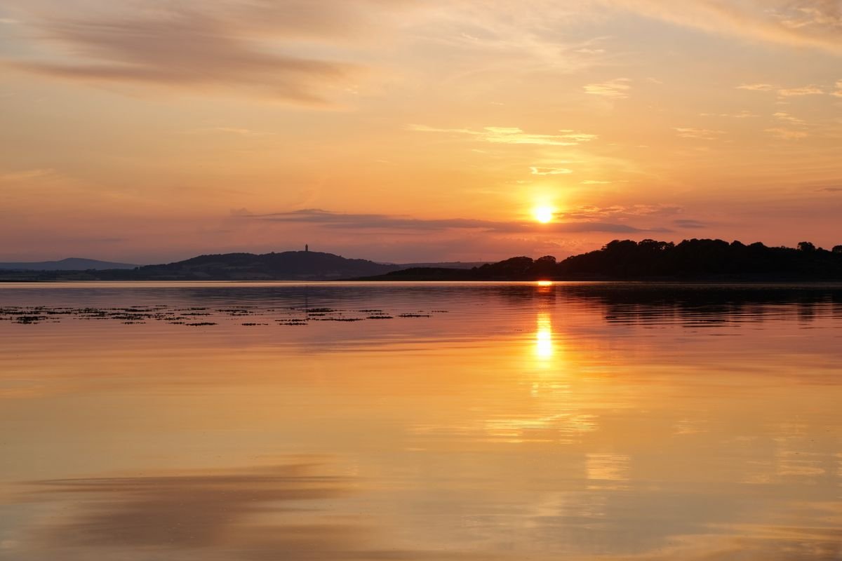 Golden hour over the Antrim coast, when the light is best for photos.