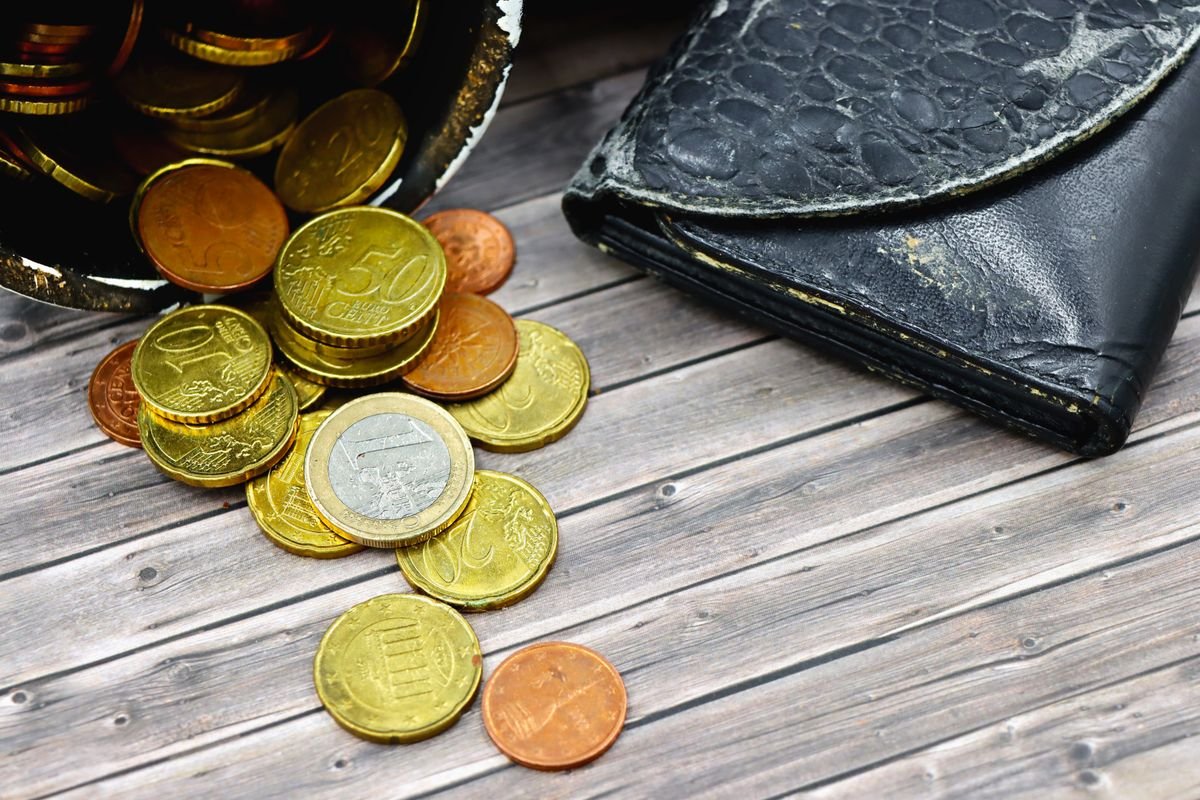 Euro coins and a wallet on a table
