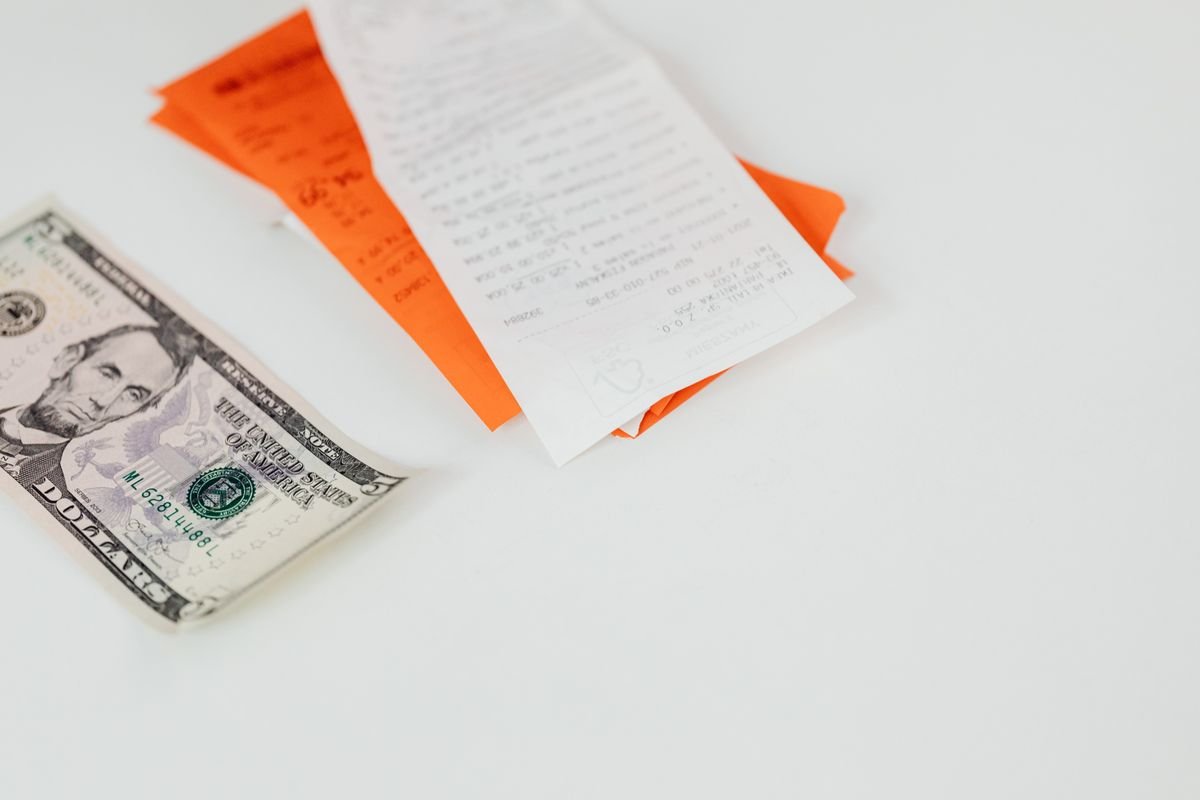 A restaurant bill and cash on a table