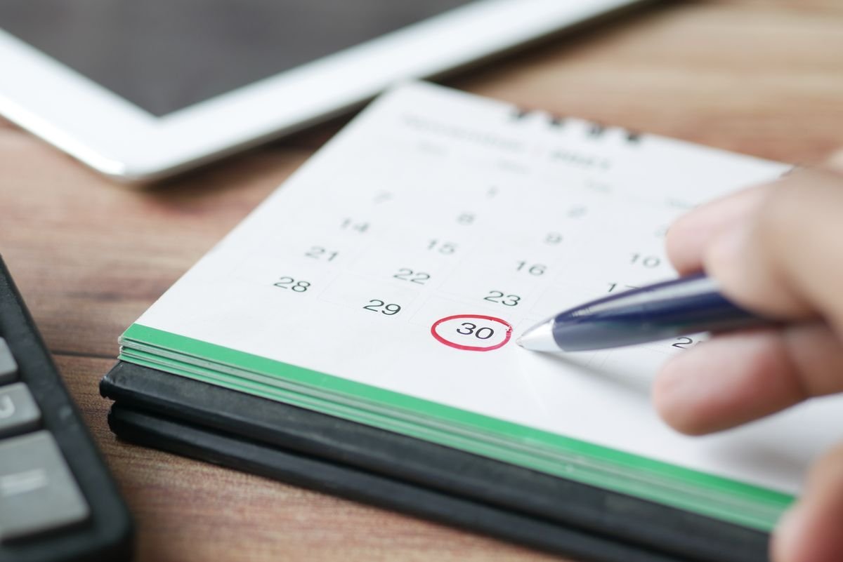 A calendar and pen for trip planning