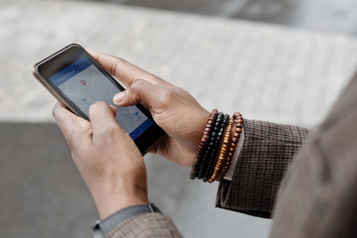 A hand holding a phone with a map app