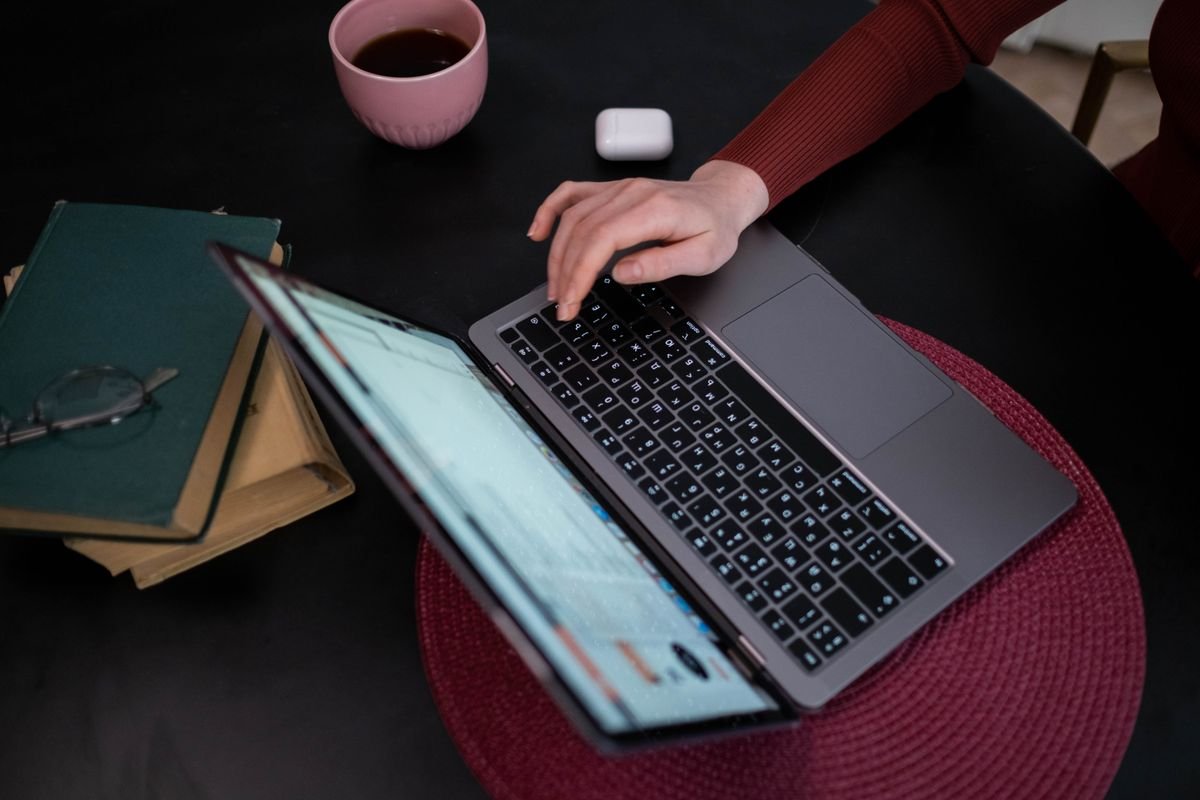 Hands booking travel on a laptop