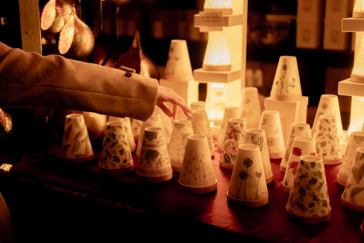 A Christmas market stall lit up after dark