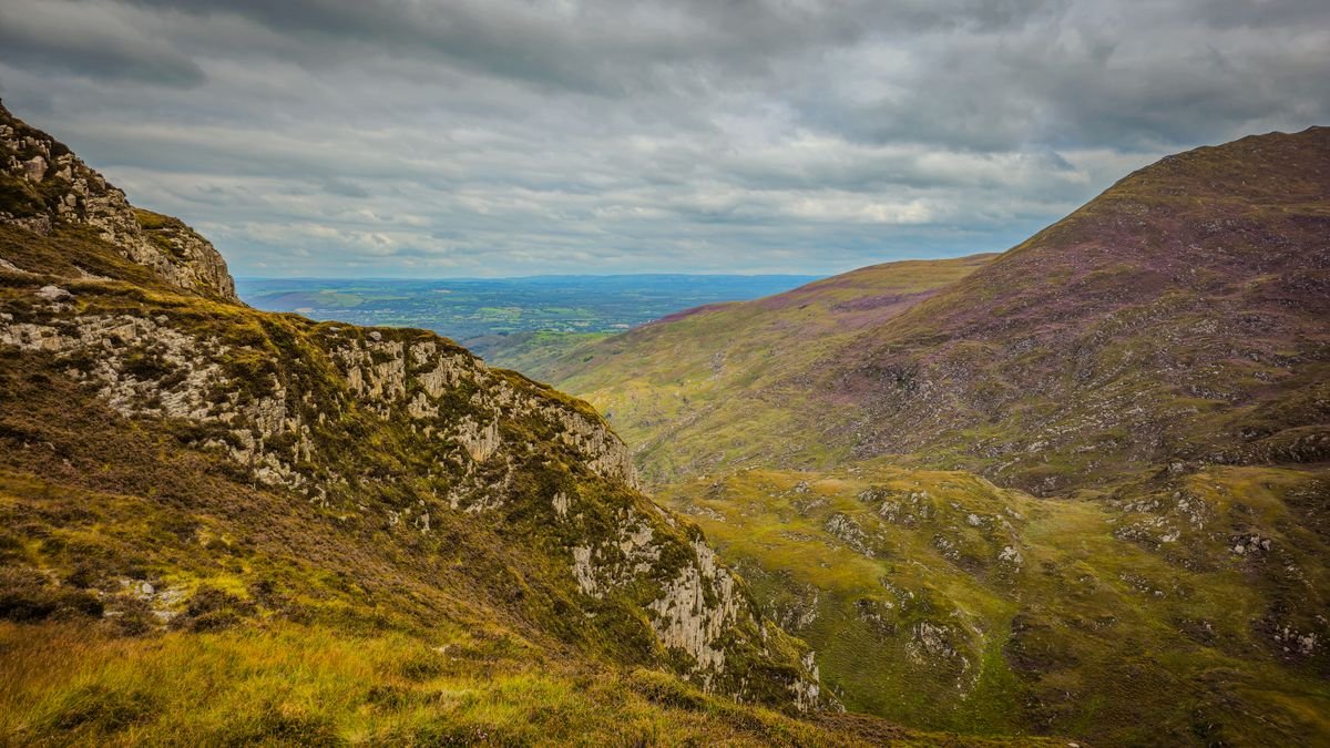 Green Irish hills under a changeable cloudy summer sky