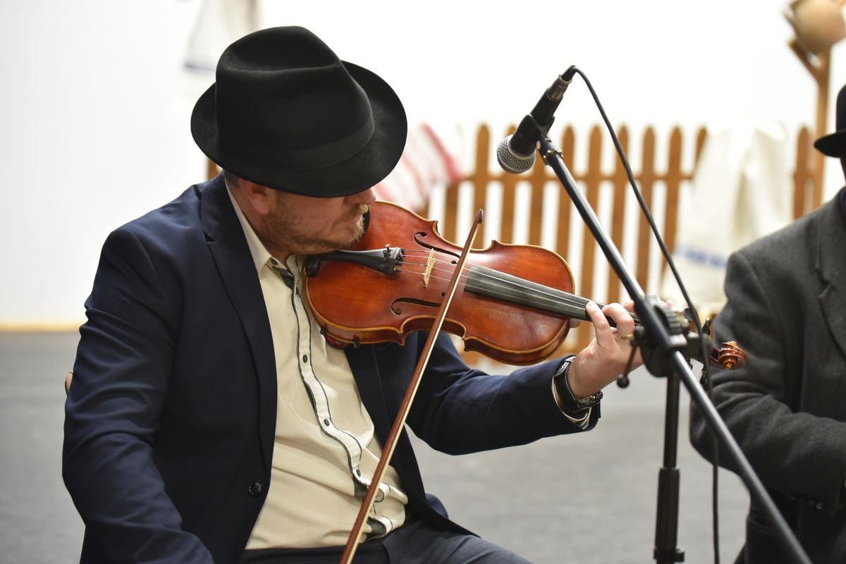 A musician playing fiddle at a traditional Irish music session