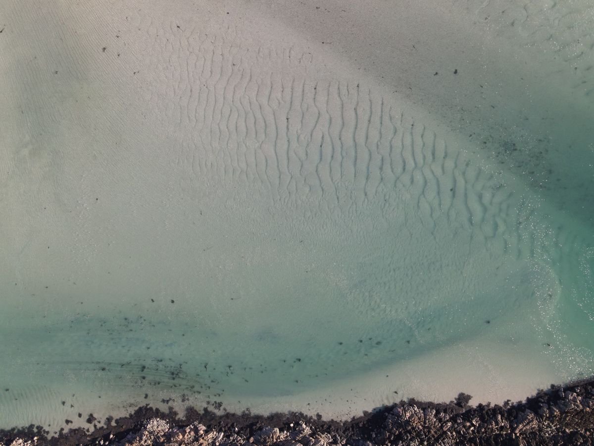 Clear turquoise water over white sand on the Irish west coast