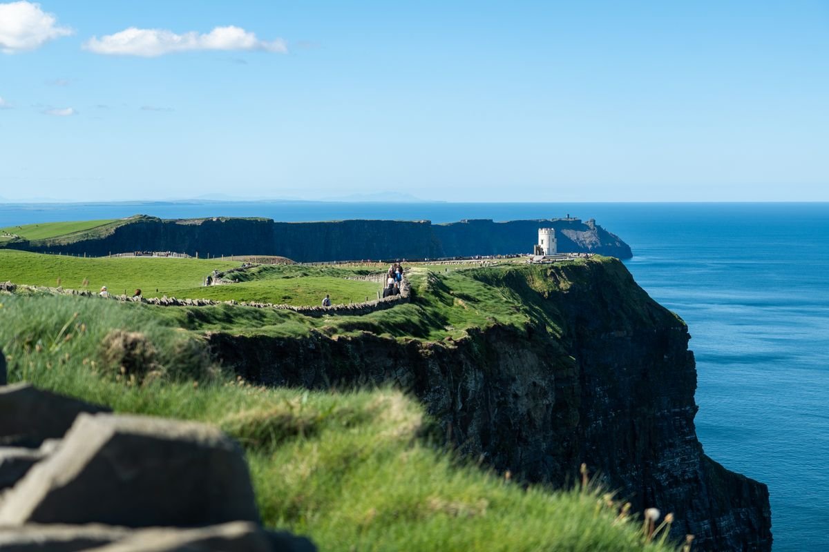 Visitors walking the path at the Cliffs of Moher in summer