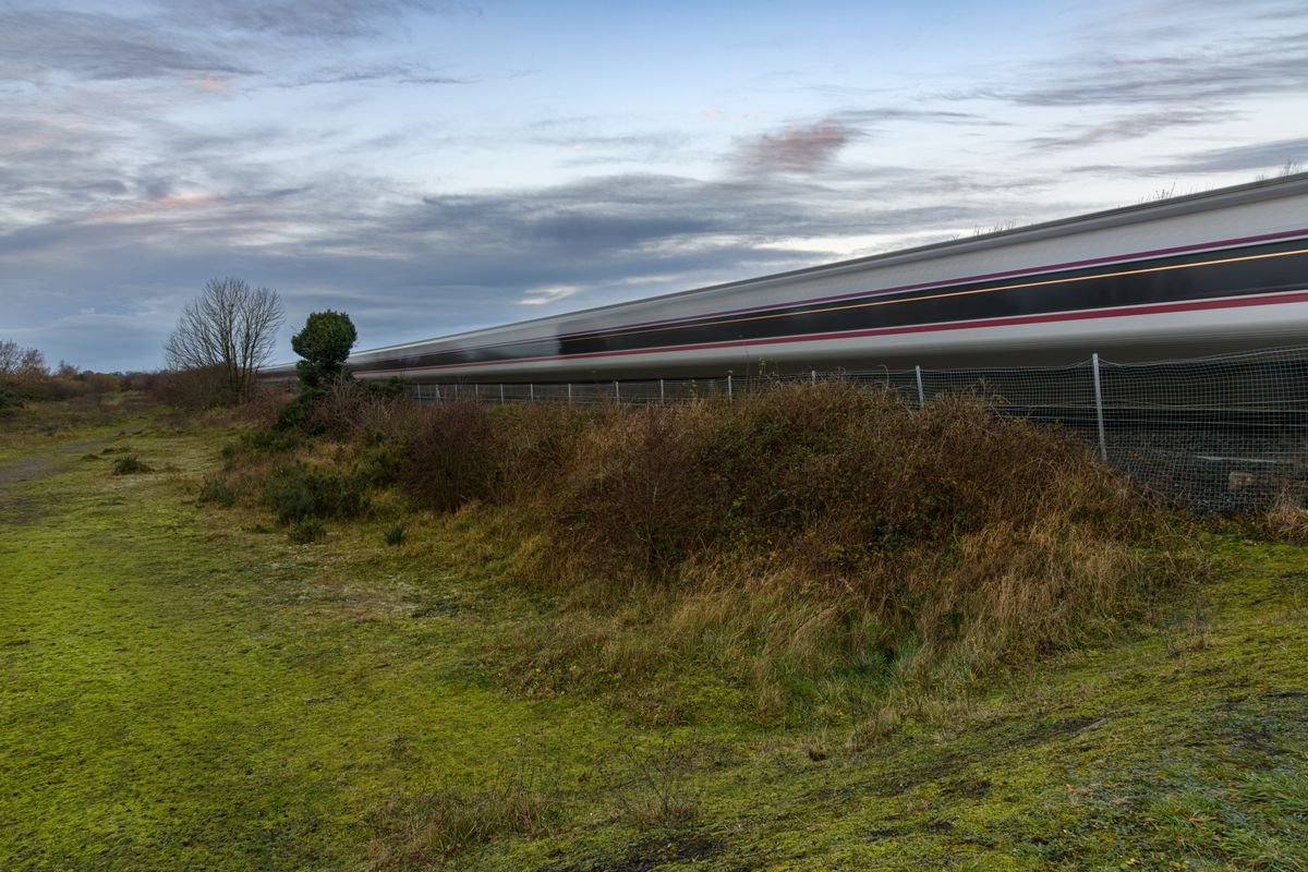 Irish Rail intercity train blurred in motion through green Irish countryside