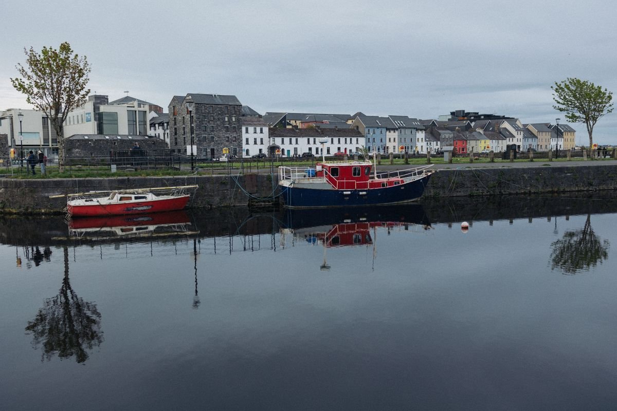 Galway's Long Walk with colourful houses reflected in the water