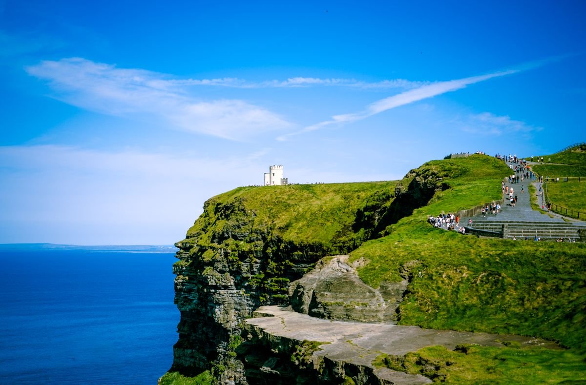 Crowds of visitors at the Cliffs of Moher with O'Brien's Tower in summer