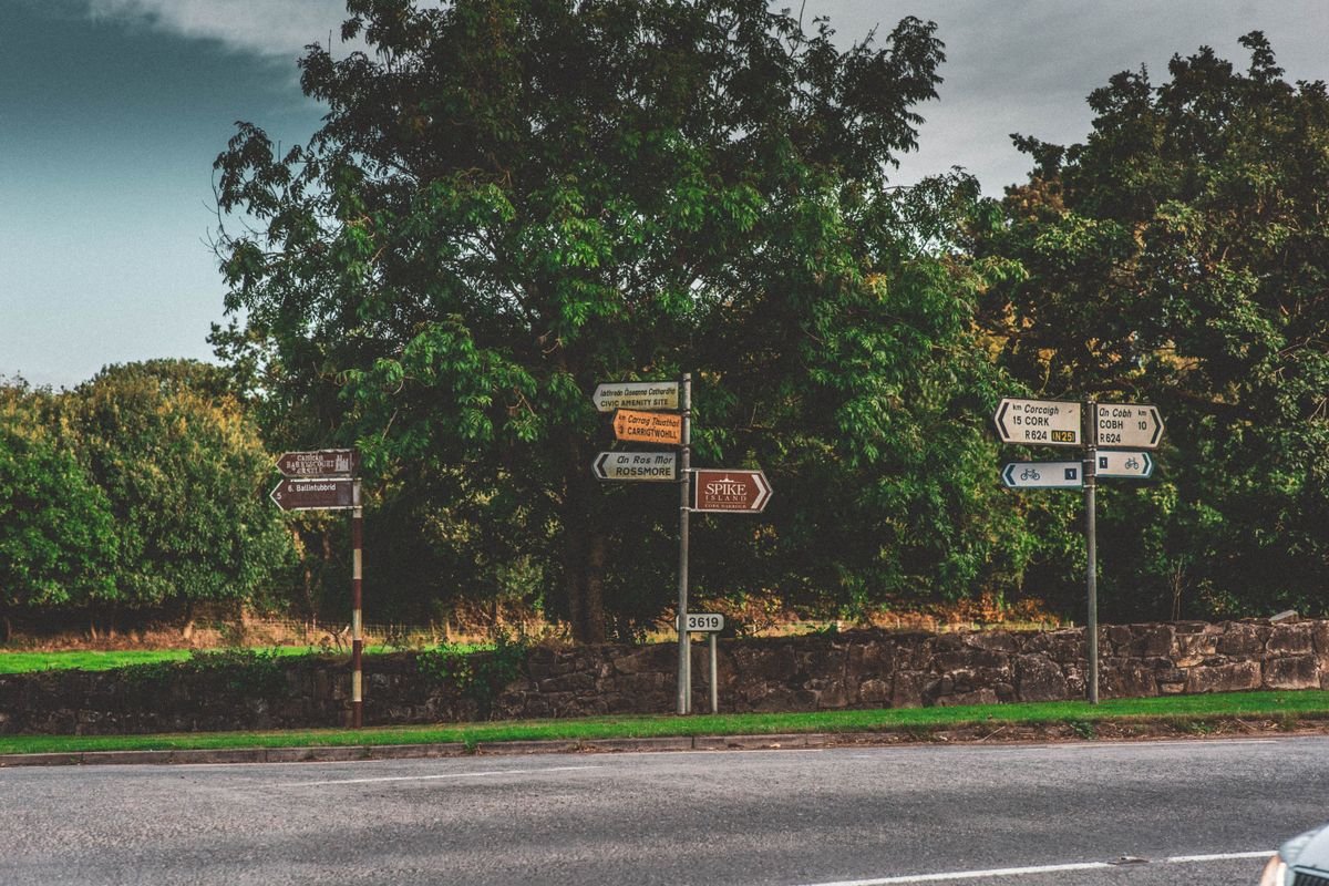 An Irish road junction with directional signposts pointing to Cork and Cobh