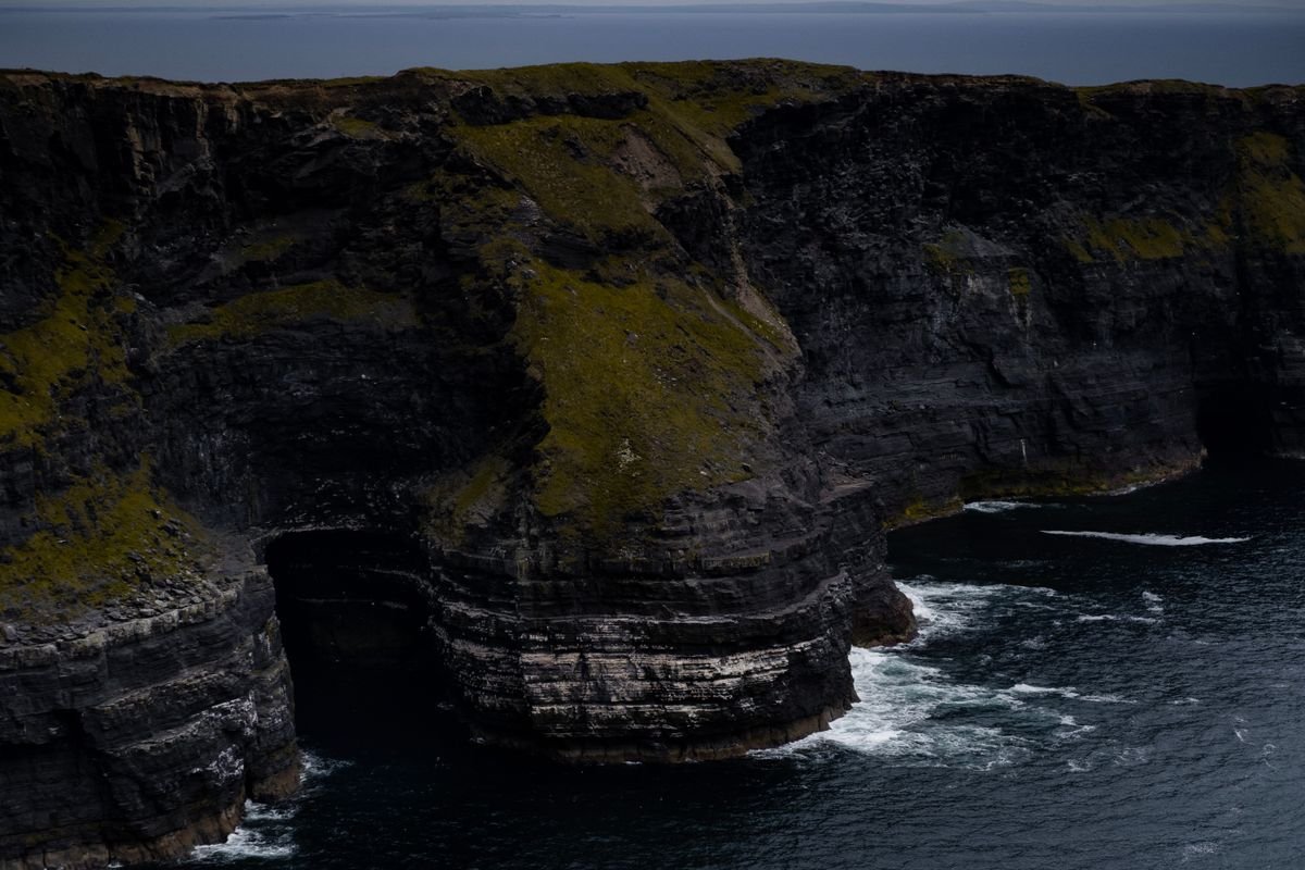 Dramatic dark sea cliffs dropping into the Atlantic on Ireland's coast