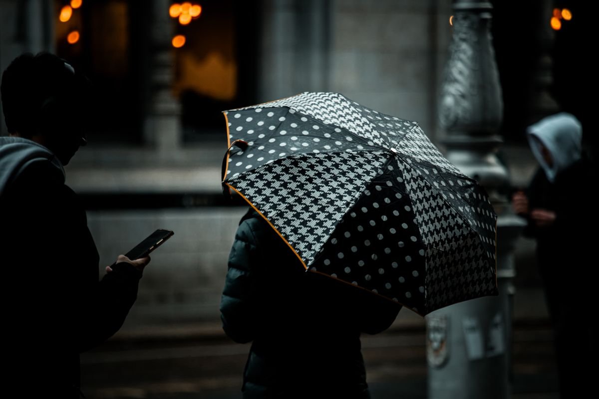 Person under an umbrella on a wet dark city street in Dublin in November