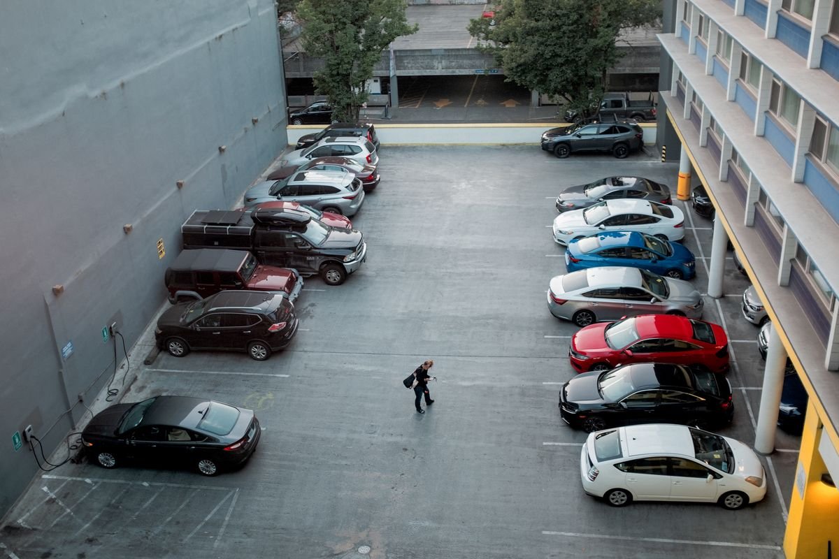 Open-air car parking lot full of parked cars