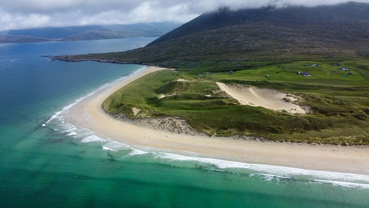 Turquoise water and a sandy beach with dunes on the west coast of Ireland
