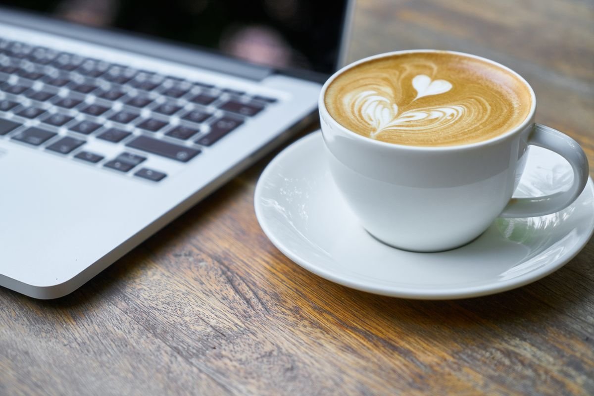 A laptop and coffee in a cafe
